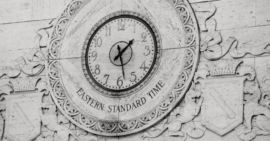 Building Standards - Engraving of emblem with clock on stone wall