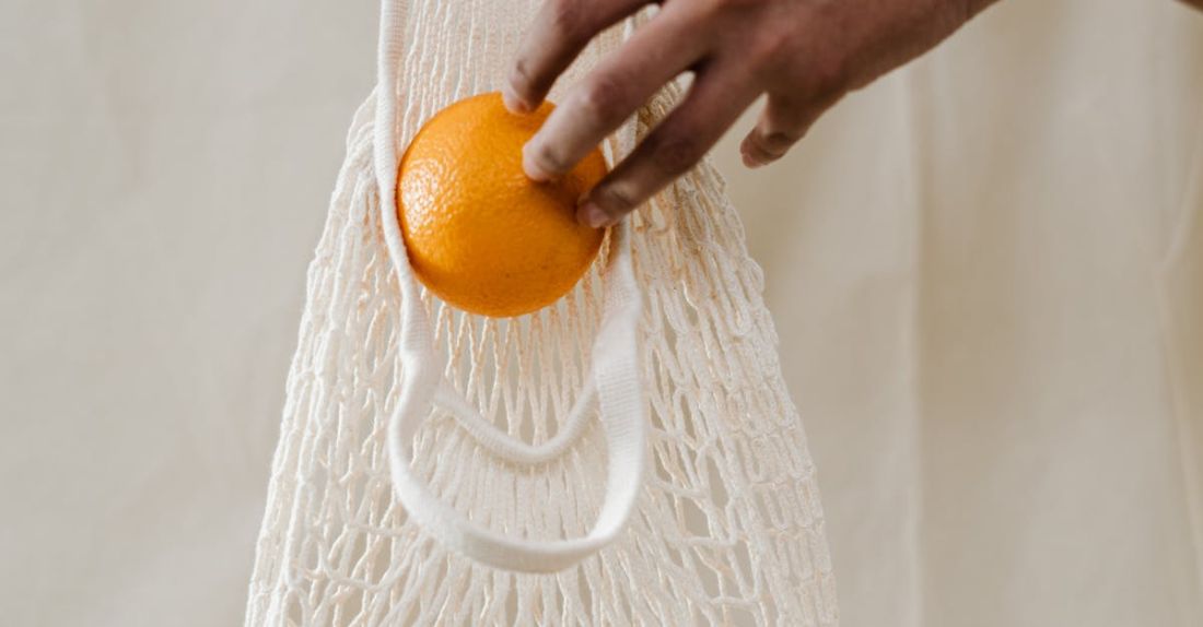 Zero Waste - Person Holding Orange Fruits in White Net