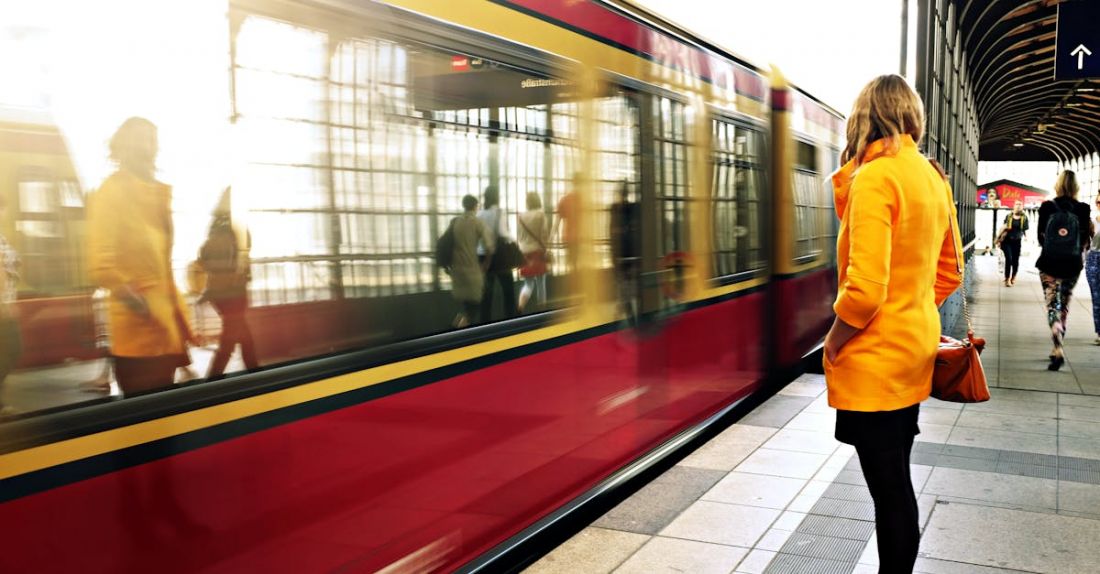 Public Transportation - Woman Standing Beside Red Train